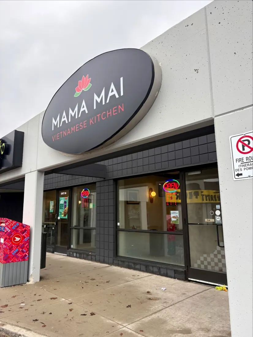 Mama Mai storefront with the round dark MAMA MAI sign